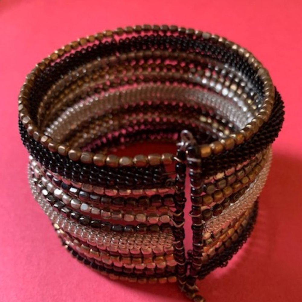 Beaded cuff bracelet with black silver and gold colors